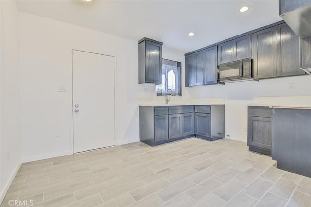 343 E 98th St, Los Angeles, CA 90003 - kitchen featuring black microwave, recessed lighting, and light countertops