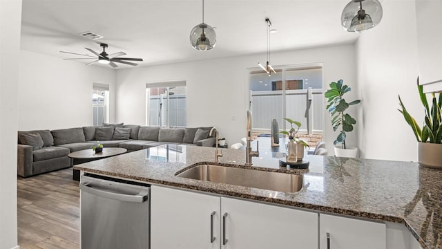 220 Perennial Pl, Fallbrook, CA 92028 - kitchen with dishwasher, decorative light fixtures, light wood-style flooring, white cabinets, and dark stone counters