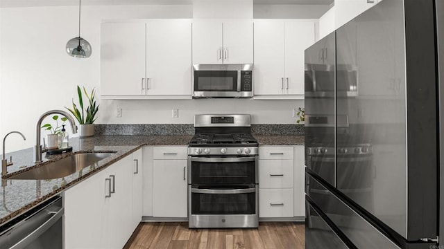 220 Perennial Pl, Fallbrook, CA 92028 - kitchen featuring stainless steel appliances, wood finished floors, white cabinets, pendant lighting, and dark stone countertops