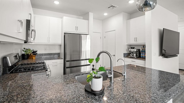 220 Perennial Pl, Fallbrook, CA 92028 - kitchen featuring stainless steel appliances, dark stone countertops, a peninsula, white cabinetry, and recessed lighting