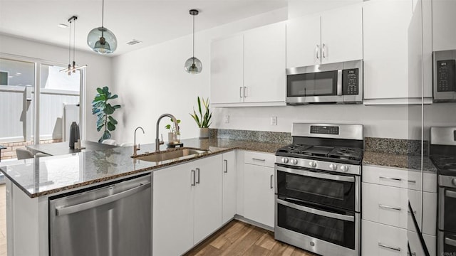 220 Perennial Pl, Fallbrook, CA 92028 - kitchen featuring stainless steel appliances, a peninsula, light wood finished floors, white cabinets, and dark stone countertops