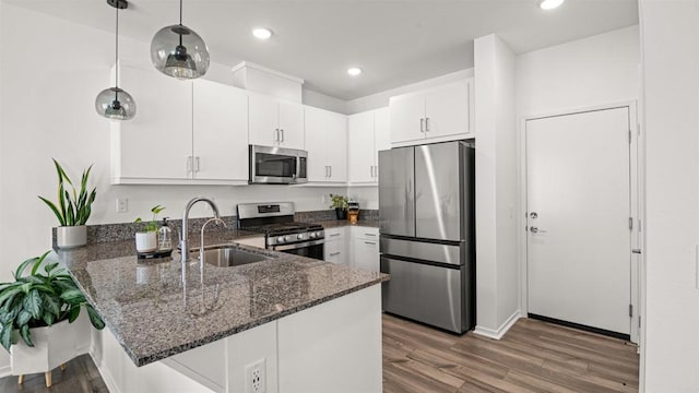 220 Perennial Pl, Fallbrook, CA 92028 - kitchen featuring stainless steel appliances, a peninsula, wood finished floors, dark stone counters, and recessed lighting