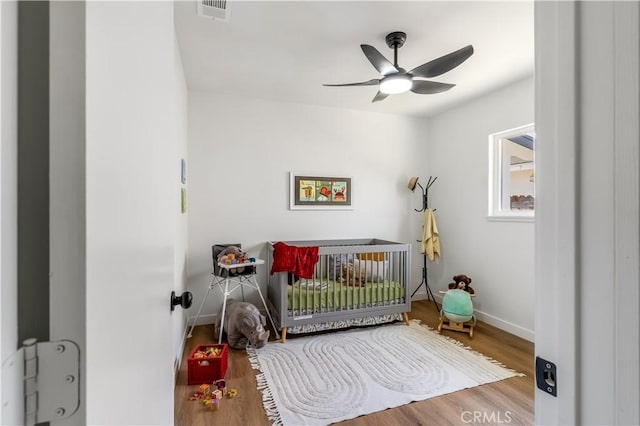 19436 Chaparral St, Rialto, CA 92376 - bedroom featuring a nursery area, wood finished floors, and a ceiling fan