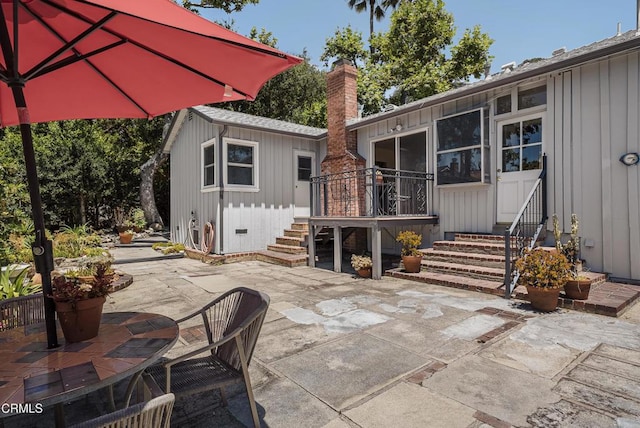 3254 Los Olivos Ln, La Crescenta, CA 91214 - rear view of house with a patio, board and batten siding, a chimney, and entry steps