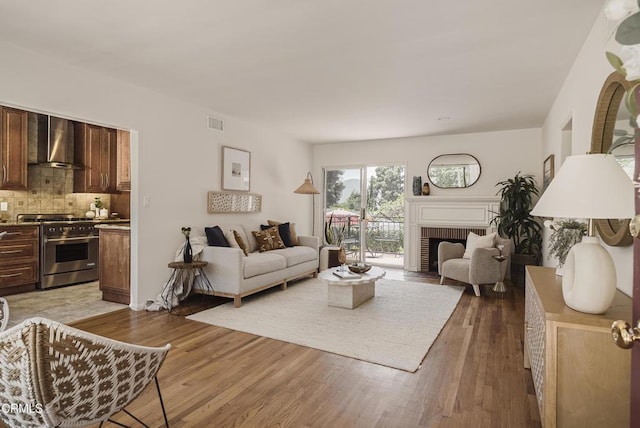 3254 Los Olivos Ln, La Crescenta, CA 91214 - living room with light wood-style floors and a brick fireplace