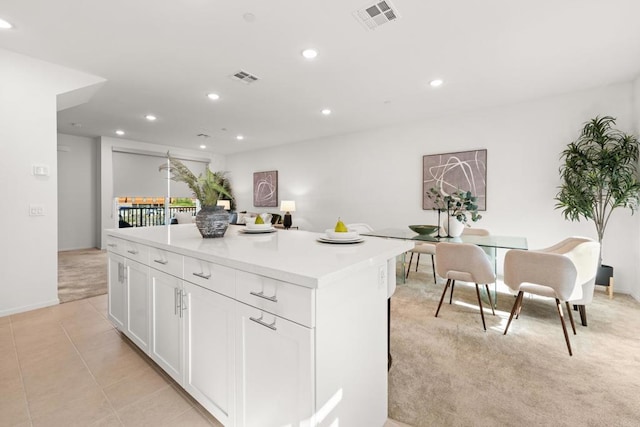 2310 Stardust Gln, Escondido, CA 92025 - kitchen featuring recessed lighting, a kitchen island, white cabinetry, light countertops, and light carpet