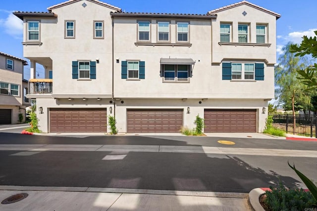 2310 Stardust Gln, Escondido, CA 92025 - view of front of house featuring stucco siding, an attached garage, and a tile roof