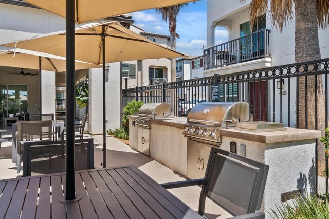 2310 Stardust Gln, Escondido, CA 92025 - wooden terrace with an outdoor kitchen, outdoor dining area, a patio area, and a ceiling fan