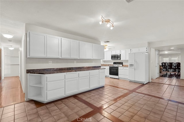 4790 Adam Rd, Simi Valley, CA 93063 - kitchen with white appliances, white cabinets, light tile patterned floors, and dark countertops