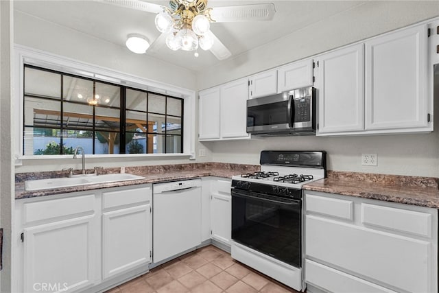 4790 Adam Rd, Simi Valley, CA 93063 - kitchen with white dishwasher, stainless steel microwave, gas stove, white cabinets, and a ceiling fan