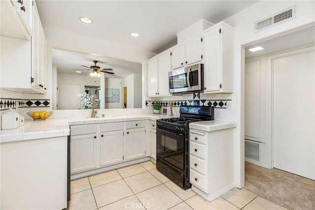14315 Riverside Dr Unit 209, Sherman Oaks, CA 91423 - kitchen with gas stove, stainless steel microwave, tile counters, decorative backsplash, and recessed lighting