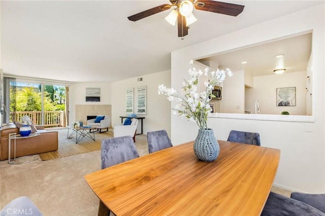 14315 Riverside Dr Unit 209, Sherman Oaks, CA 91423 - carpeted dining space with ceiling fan and a tiled fireplace