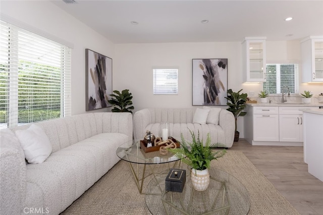 15256 Clymer St, San Fernando, CA 91345 - living room with light wood-type flooring and recessed lighting