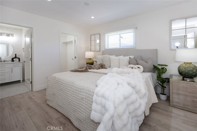 15256 Clymer St, San Fernando, CA 91345 - bedroom with light wood-type flooring, ensuite bathroom, and recessed lighting