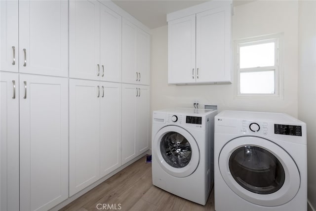 15256 Clymer St, San Fernando, CA 91345 - laundry room with cabinet space, washing machine and dryer, and light wood-type flooring