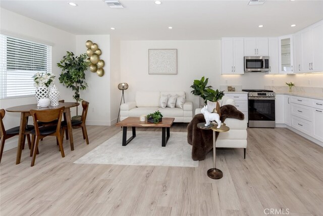 15256 Clymer St, San Fernando, CA 91345 - living area with light wood-style flooring and recessed lighting