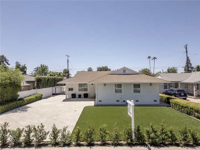 15256 Clymer St, San Fernando, CA 91345 - rear view of property featuring driveway and stucco siding