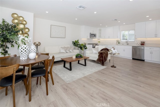 15256 Clymer St, San Fernando, CA 91345 - living area featuring light wood-style flooring and recessed lighting