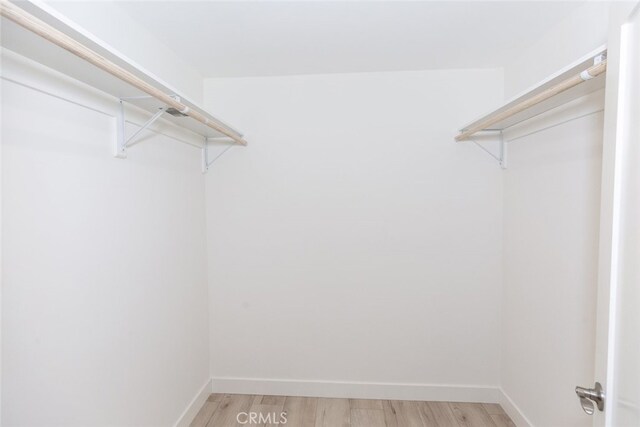 15256 Clymer St, San Fernando, CA 91345 - walk in closet with light wood finished floors