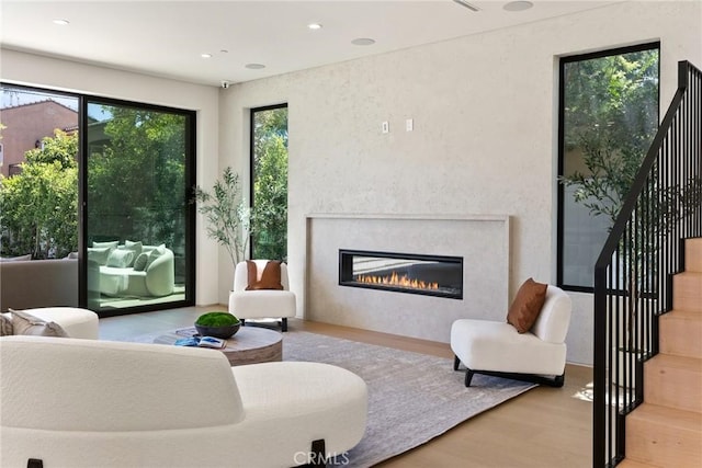 14738 Otsego St, Sherman Oaks, CA 91403 - living area with wood finished floors, healthy amount of natural light, a glass covered fireplace, stairway, and recessed lighting