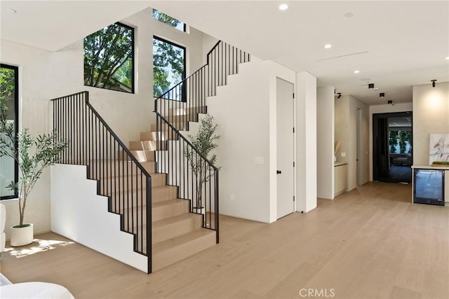 14738 Otsego St, Sherman Oaks, CA 91403 - staircase featuring wood finished floors, beverage cooler, and recessed lighting