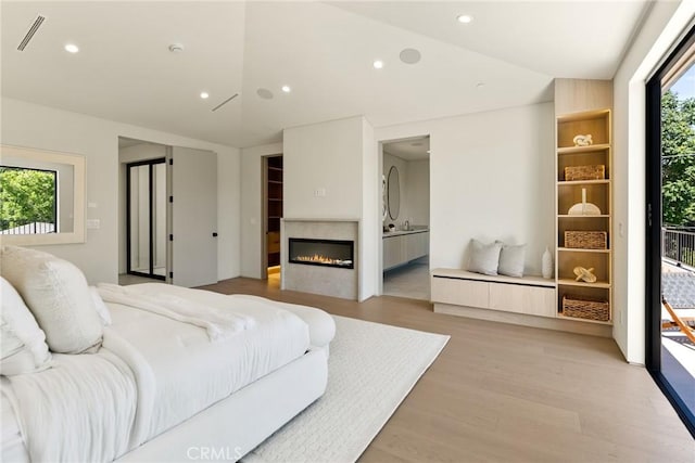 14738 Otsego St, Sherman Oaks, CA 91403 - bedroom featuring light wood-style flooring, a glass covered fireplace, recessed lighting, access to outside, and ensuite bathroom