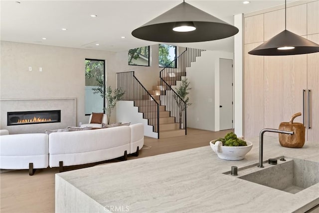 14738 Otsego St, Sherman Oaks, CA 91403 - living room with light wood-type flooring, stairway, recessed lighting, and a glass covered fireplace