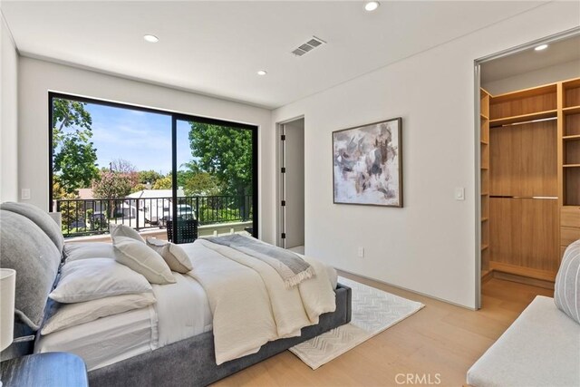 14738 Otsego St, Sherman Oaks, CA 91403 - bedroom featuring light wood-style floors, access to exterior, recessed lighting, and a walk in closet