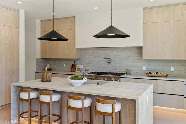 14738 Otsego St, Sherman Oaks, CA 91403 - kitchen featuring modern cabinets, a kitchen bar, and light stone counters
