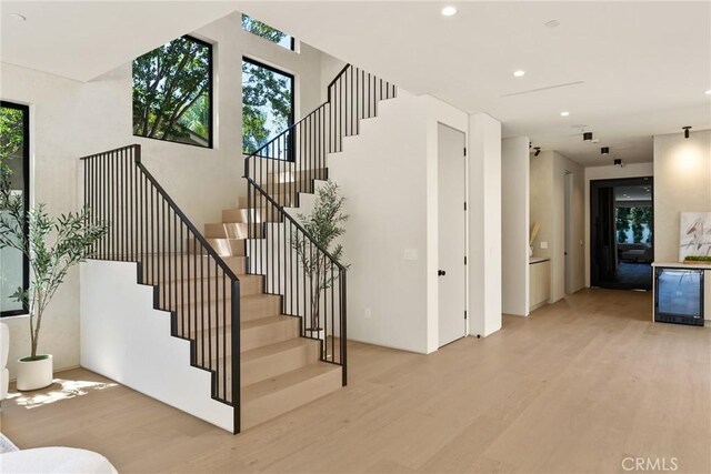 14738 Otsego St, Sherman Oaks, CA 91403 - staircase with wood finished floors, wine cooler, and recessed lighting