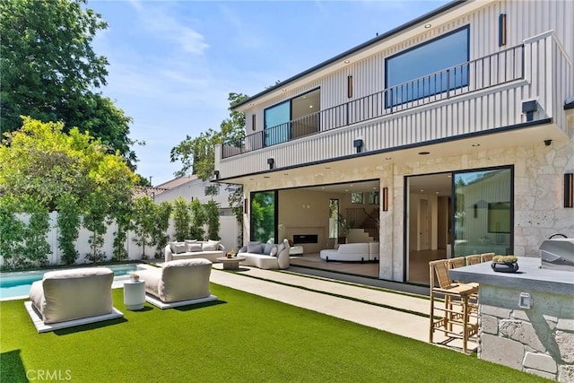 14738 Otsego St, Sherman Oaks, CA 91403 - rear view of property featuring a balcony, outdoor lounge area, a fenced backyard, and a patio area