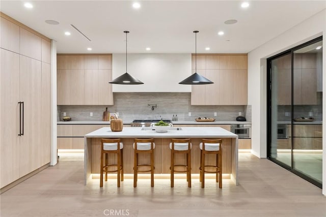 14738 Otsego St, Sherman Oaks, CA 91403 - kitchen featuring modern cabinets, light brown cabinetry, a breakfast bar area, light countertops, and recessed lighting