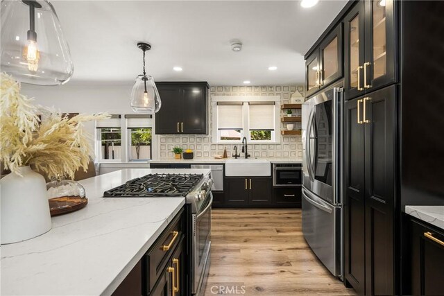 705 E Palm Ave, Orange, CA 92866 - kitchen with stainless steel appliances, healthy amount of natural light, decorative backsplash, light stone counters, and recessed lighting