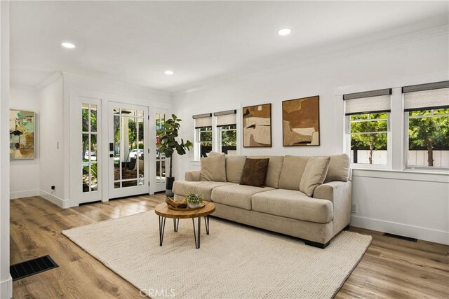 705 E Palm Ave, Orange, CA 92866 - living area featuring ornamental molding, wood finished floors, recessed lighting, and french doors