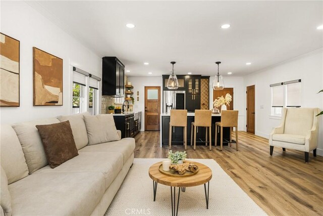 705 E Palm Ave, Orange, CA 92866 - living area featuring recessed lighting, light wood-style flooring, and ornamental molding