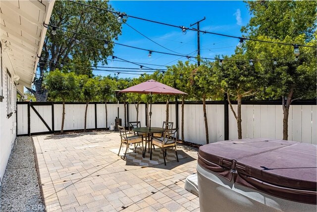 705 E Palm Ave, Orange, CA 92866 - fenced backyard featuring a hot tub, a patio, and outdoor dining area