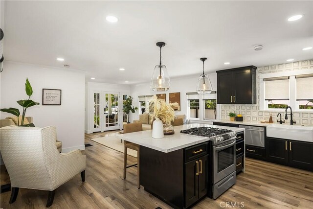 705 E Palm Ave, Orange, CA 92866 - kitchen featuring appliances with stainless steel finishes, light countertops, plenty of natural light, a kitchen bar, and recessed lighting