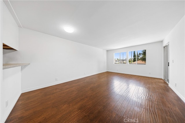 1629 Cherry Ave Unit 102, Long Beach, CA 90813 - unfurnished living room with dark wood-style floors and baseboards