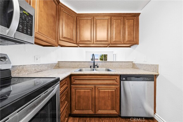 1629 Cherry Ave Unit 102, Long Beach, CA 90813 - kitchen with appliances with stainless steel finishes, light countertops, and brown cabinetry
