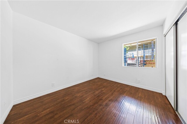 1629 Cherry Ave Unit 102, Long Beach, CA 90813 - unfurnished bedroom featuring dark wood-style flooring and a closet