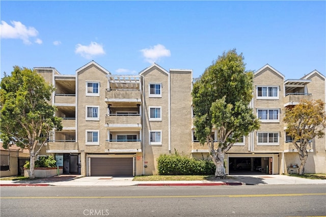 1629 Cherry Ave Unit 102, Long Beach, CA 90813 - view of apartment building / complex featuring a garage and concrete driveway