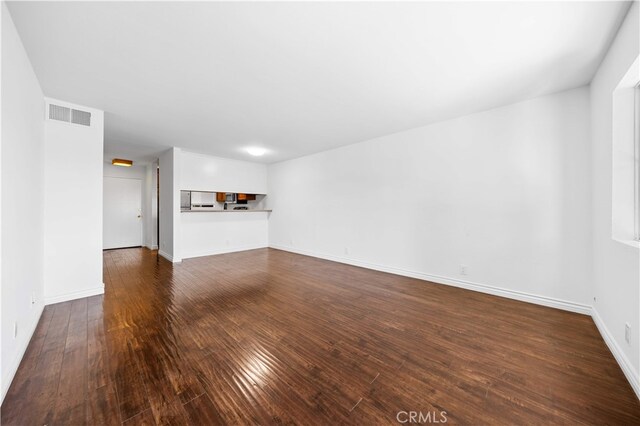 1629 Cherry Ave Unit 102, Long Beach, CA 90813 - unfurnished living room with dark wood finished floors and baseboards