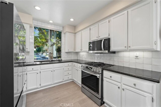 26 Le Vanto, Irvine, CA 92606 - kitchen with gas stove, white cabinetry, light wood-style flooring, backsplash, and recessed lighting