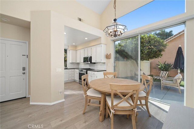 26 Le Vanto, Irvine, CA 92606 - dining space with a chandelier, light wood-style flooring, and recessed lighting