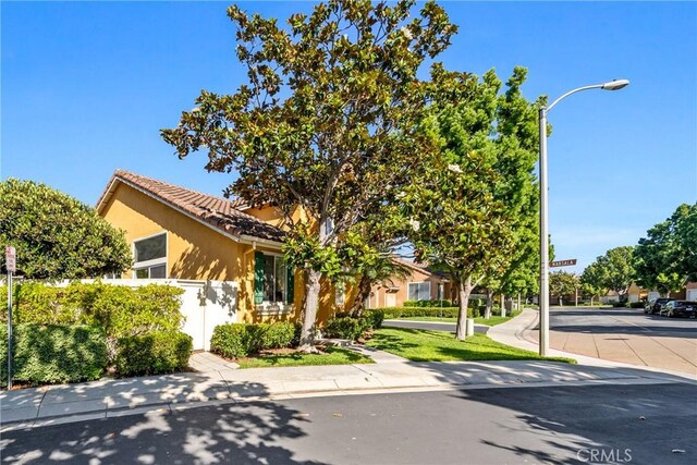 26 Le Vanto, Irvine, CA 92606 - view of front of house featuring a tile roof and stucco siding
