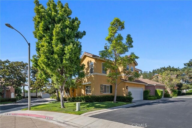 26 Le Vanto, Irvine, CA 92606 - view of front of house with stucco siding, a tile roof, and a front yard