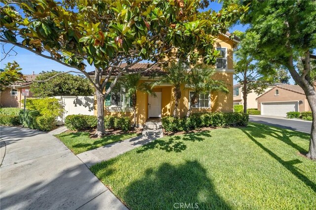 26 Le Vanto, Irvine, CA 92606 - view of property hidden behind natural elements with stucco siding and a garage