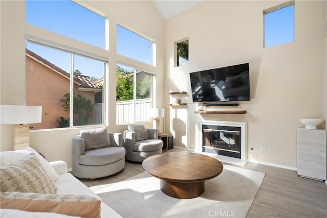 26 Le Vanto, Irvine, CA 92606 - living room featuring wood finished floors, a glass covered fireplace, and high vaulted ceiling