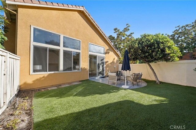 26 Le Vanto, Irvine, CA 92606 - back of house with stucco siding, a fenced backyard, and a patio area