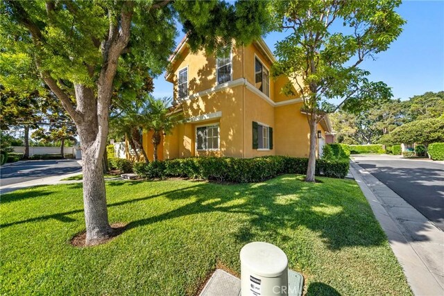 26 Le Vanto, Irvine, CA 92606 - view of home's exterior with stucco siding and a lawn